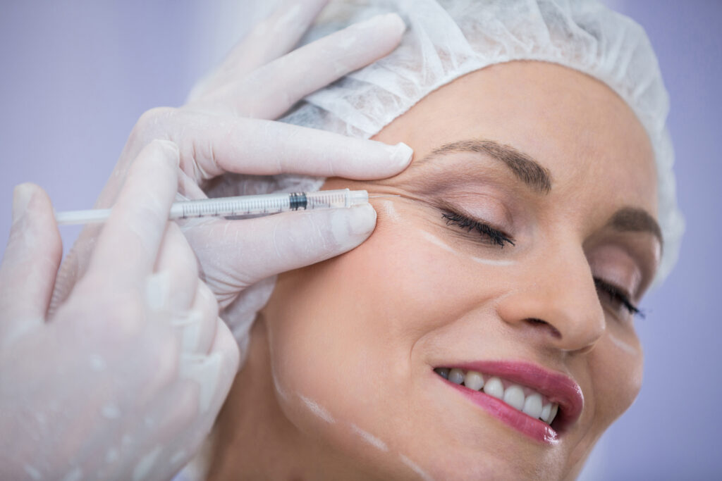 Close-up of woman receiving botox injection at clinic